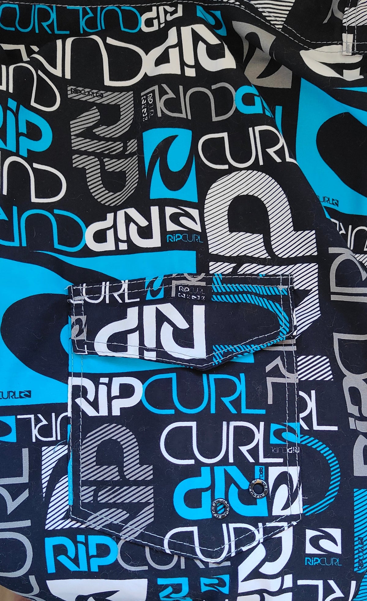 Rip Curl Board Shorts – All-Over Logo Print (Size 38)