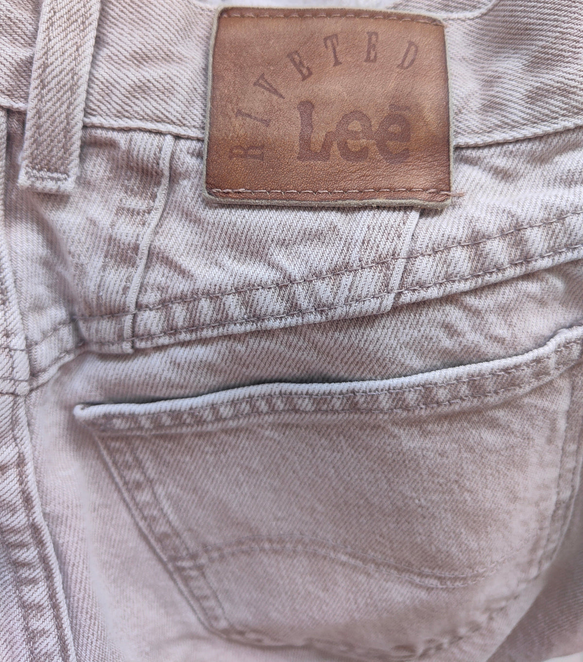 Full view of pale grey-taupe Lee straight-leg jeans