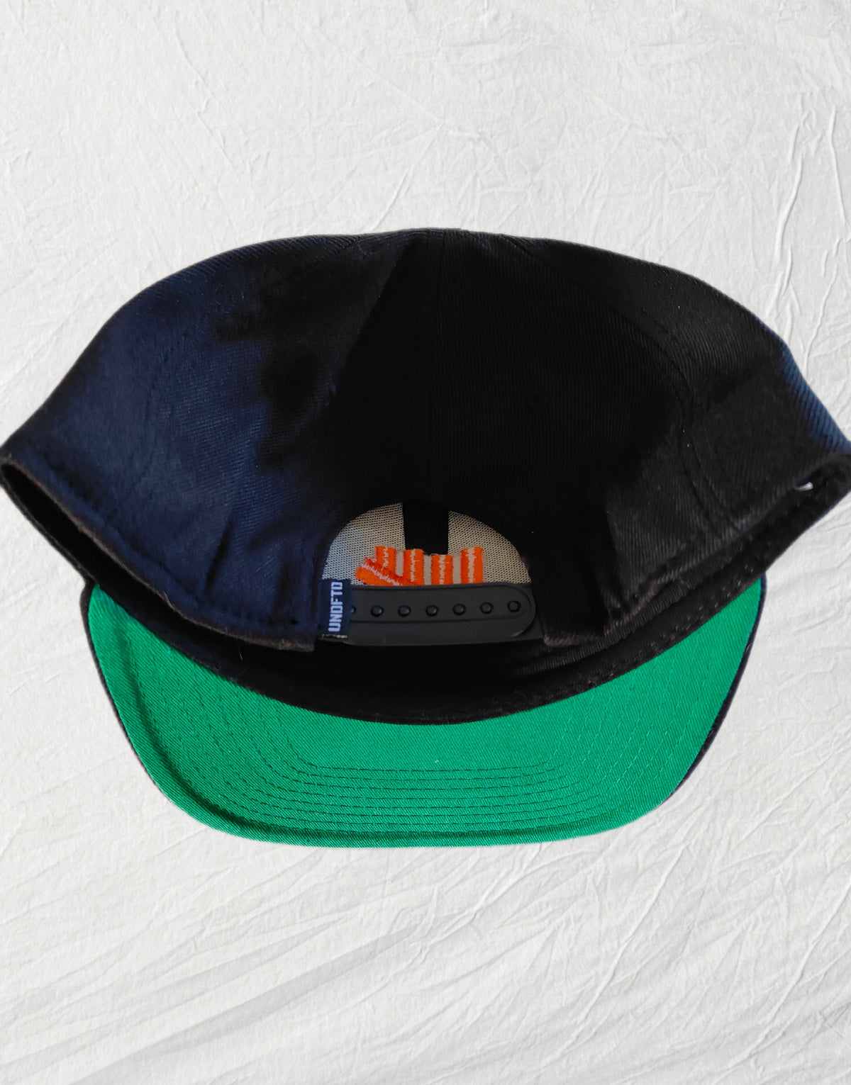 Undefeated Snapback – Black / Orange Logo